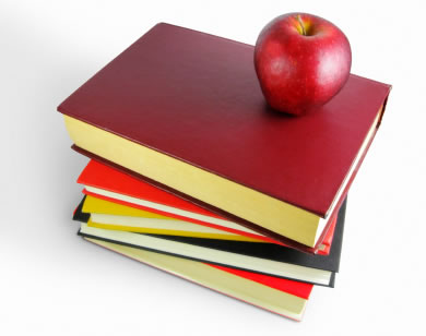 stack of books with apple
