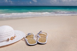 hat and sandals on a beach